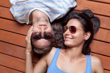 Mutlu genç çift ahşap bir yerde yatarken