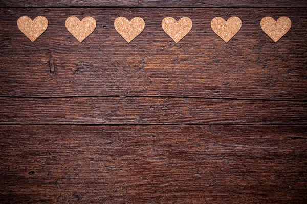 Small hearts on a wooden background