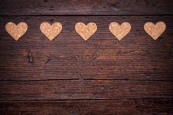 Small hearts on a wooden background