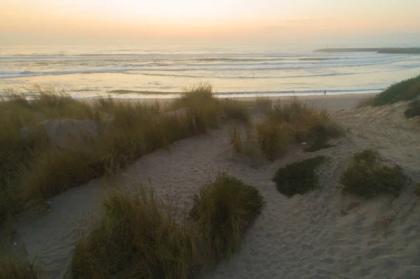 Drone top down view of a stone breakwater and turquoise sea in Galicia