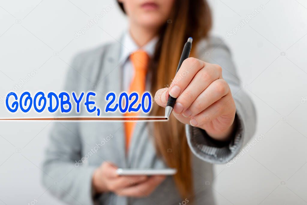 Handwriting text writing Goodbye 2020. Concept meaning New Year Eve Milestone Last Month Celebration Transition Model displaying different shots of holding pen ready for promotional use.
