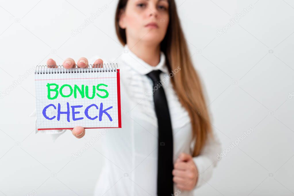 Text sign showing Bonus Check. Conceptual photo something in addition to what is expected or strictly due Model displaying different empty color notepad mock-up for writing idea.