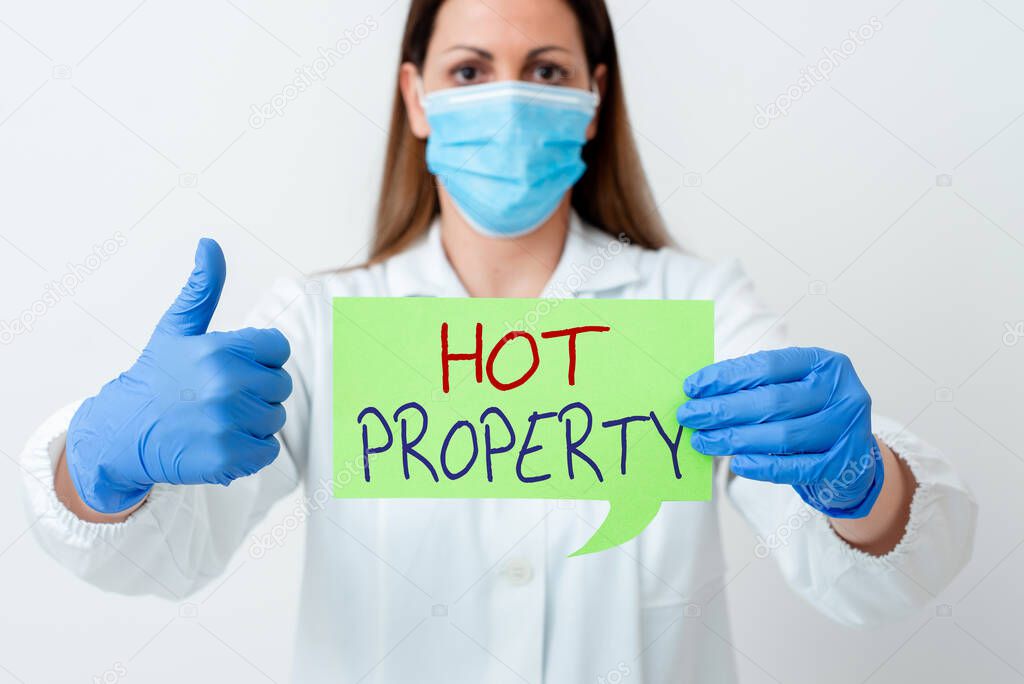 Word writing text Hot Property. Business concept for Something which is sought after or is Heavily Demanded Laboratory technician featuring empty sticker paper accessories smartphone.
