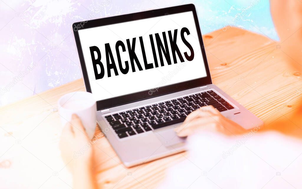 Conceptual hand writing showing Backlinks. Business photo text links from one website to a page on another website or page Modern gadgets white screen under colorful bokeh background.