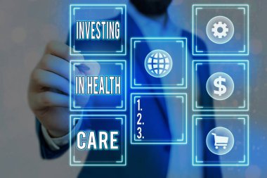 Sağlık Hizmetlerine Yatırım 'ı gösteren bir not yazıyorum. İş fotoğraflarının sergilenmesi, sağlık şebekeleri ve farklı simgelerin bakımına veya iyileştirilmesine para yatırdı.