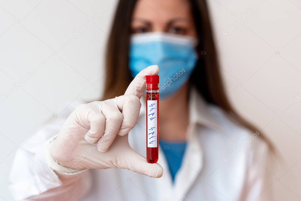 Word writing text Stay Safe. Business concept for secure from threat of danger, harm or place to keep articles Laboratory blood test sample shown for medical diagnostic analysis result.