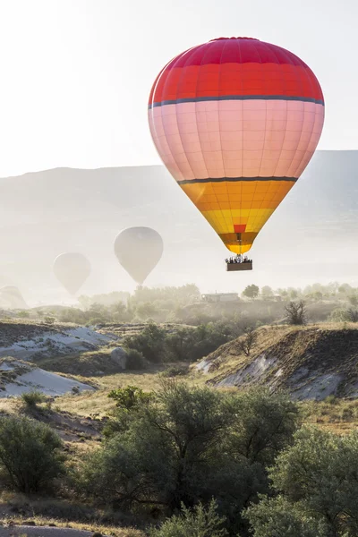 Hot air balloon flying over Cappadocia — Stock Photo, Image
