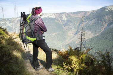 Girl with looks out over the mountains, Czech mountains Krkonose clipart