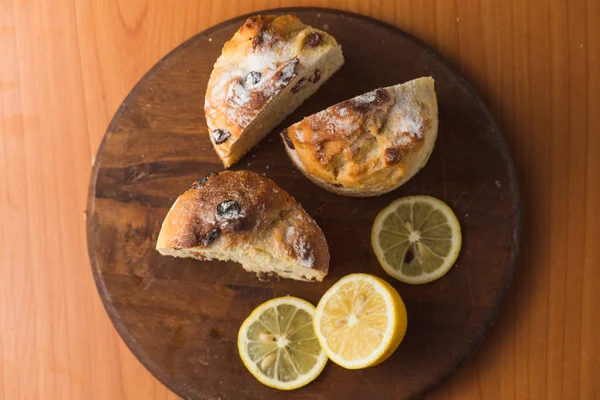 Верхний вид кекса с лимоном в чашке и на деревянном столе — стоковое фото