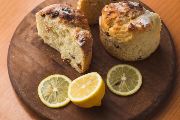 Верхний вид кекса с лимоном в чашке и на деревянном столе — стоковое фото
