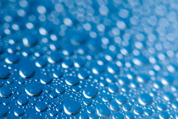 Close-up of water drops on the blue background — Stock Photo, Image