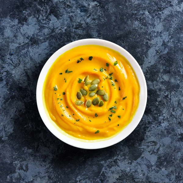 Close up of pumpkin puree in a bowl over blue stone background. Healthy diet food concept. Top view, flat lay — Stock Image Close Pumpkin Puree Bowl Blue Stone Background Healthy Diet Food Royalty Free Stock Images