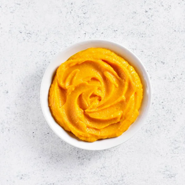 Pumpkin puree in bowl over light stone background with free text space. Healthy diet food concept. Top view, flat lay — Stock Image Pumpkin Puree Bowl Light Stone Background Free Text Space Healthy Stock Photo