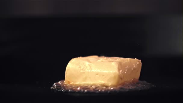 Super câmera lenta na panela derrete um pedaço de manteiga. Filmado em uma câmera de alta velocidade a 1000 fps. — Vídeo de Stock
