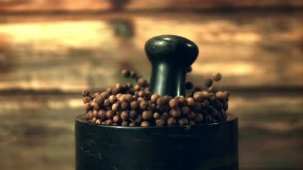 Super slow motion in a mortar with black pepper peas falls pestle. Filmed on a high-speed camera at 1000 fps. — Stock Video