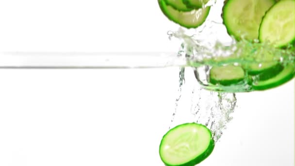 Super slow motion pieces of fresh cucumbers fall into the water with splashes. Filmed on a high-speed camera at 1000 fps. — Stock Video