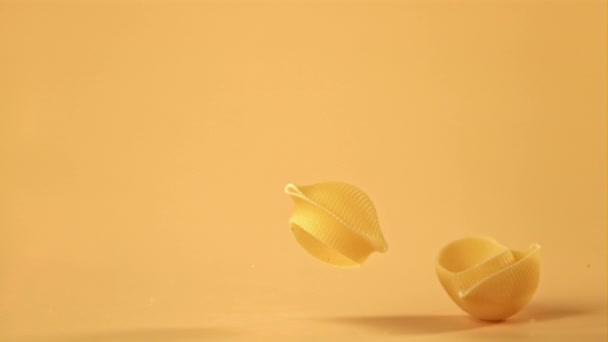 Super slow motion pasta rigate dry falls on the table. Filmed on a high-speed camera at 1000 fps. — Stock Video