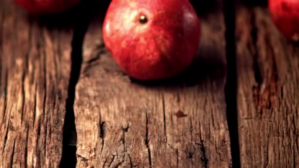 Super slow motion ripe pomegranats roll down wooden boards. Filmed on a high-speed camera at 1000 fps. — Stock Video