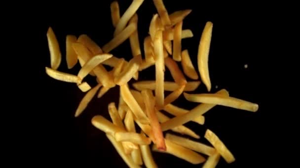 Super slow motion French fries flying in the air against a black background. Filmed on a high-speed camera at 1000 fps. — Stok Video
