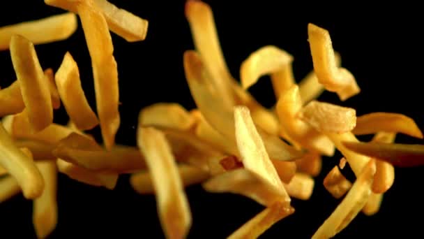 Super slow motion french fries flying against a black background. Filmed on a high-speed camera at 1000 fps. — Αρχείο Βίντεο