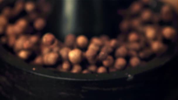 Super slow movement from the mortar fall out of the peas of black pepper. Filmed on a high-speed camera at 1000 fps. — Wideo stockowe