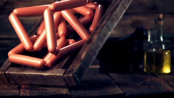 Super slow motion wooden tray with sausages falls on the table.Filmed on a high-speed camera at 1000 fps. — Stock Video