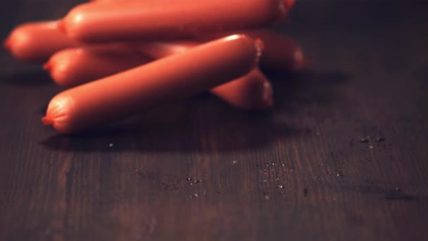 Super slow motion sausages roll on the table. Filmed on a high-speed camera at 1000 fps. — Stock Video
