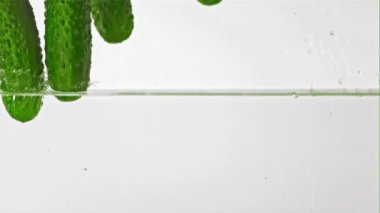 Süper yavaş çekimde salatalıklar suya su sıçratarak düşer. 1000 fps hızla yüksek hızlı bir kamerayla çekildi..