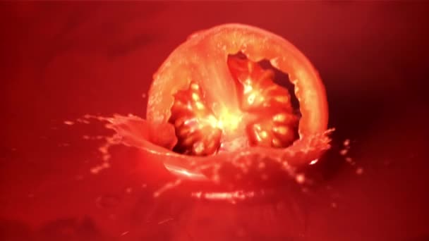 Super slow motion round a piece of tomato falls into the tomato juice. Filmed at 1000 fps. — Stock Video