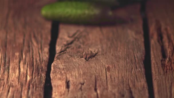 Super slow motion fresh cucumbers roll on wooden boards. Filmed on a high-speed camera at 1000 fps. — Stock Video