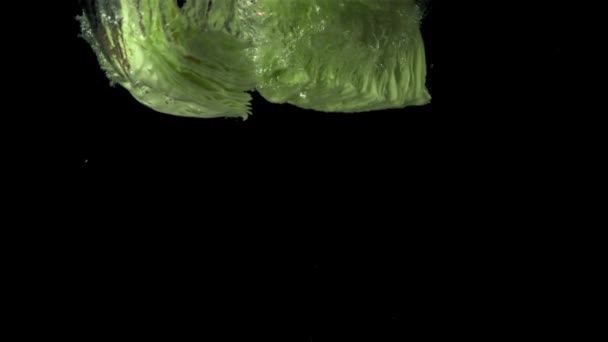 Super slow motion chunks of fresh cabbage fall under the water with air bubbles. Filmed at 1000 fps. — Stock Video