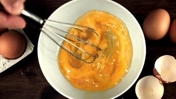 Super slow motion the mans hand stirs the raw egg with a whisk. Filmed on a high-speed camera at 1000 fps. — Stock Video