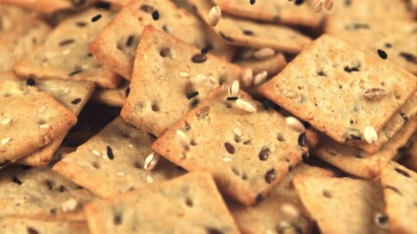 クッキーの超スローモーションは、ゴマと大麦の粒が落ちています。1000 fpsで高速カメラで撮影. — ストック動画