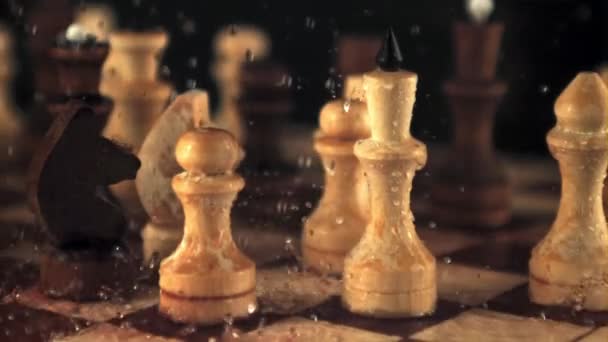 Super cámara lenta en el tablero de ajedrez con las piezas cayendo gotas de agua.Filmado en una cámara de alta velocidad a 1000 fps. — Vídeos de Stock