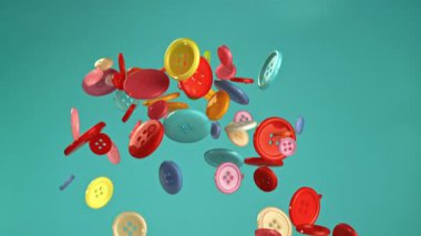 Mavi arka planda çok renkli düğmeler uçuşuyor. 1000 fps 'de yüksek hızlı bir kamerayla çekildi. Yüksek kaliteli FullHD görüntüler