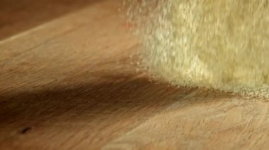Semolina ahşap bir masaya düşer. 1000 fps 'de yüksek hızlı bir kamerayla çekildi. Yüksek kaliteli FullHD görüntüler