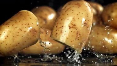 Taze patatesler masaya düşer. 1000 fps 'de yüksek hızlı bir kamerayla çekildi. Yüksek kaliteli FullHD görüntüler