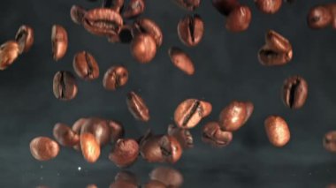 Süper yavaş çekimde dumanlı kahve çekirdekleri. 1000 fps 'de yüksek hızlı bir kamerayla çekildi. Yüksek kaliteli FullHD görüntüler