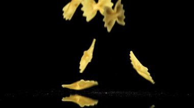 Süper yavaş çekimde kuru farfalle makarna. 1000 fps 'de yüksek hızlı bir kamerayla çekildi. Yüksek kaliteli FullHD görüntüler
