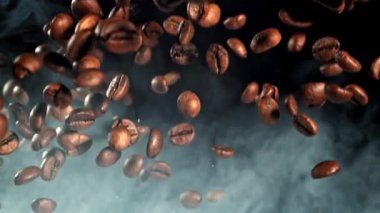 Süper yavaş çekimde dumanlı kahve çekirdekleri. 1000 fps 'de yüksek hızlı bir kamerayla çekildi. Yüksek kaliteli FullHD görüntüler