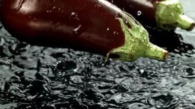 Süper yavaş çekim taze patlıcan, su sıçraması ve damla damla. 1000 fps 'de yüksek hızlı bir kamerayla çekildi. Yüksek kaliteli FullHD görüntüler