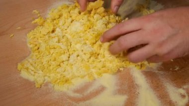 Semolina, makarna hamuru yapmak için elle yumurtayla karıştırılır.