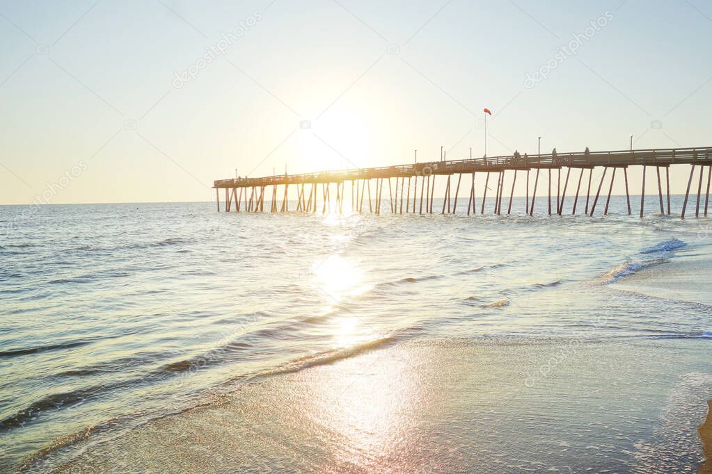 Avalon Pier and sandy beach at the Outer Banks of North Carolina at sunrise    