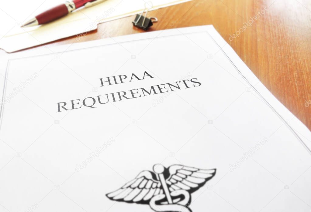 HIPAA healthcare requirements document on an office desk 