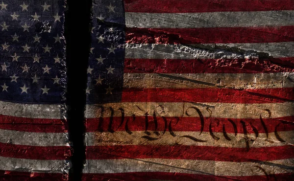 Distressed US flag split in two with We The People constitution text-- American political division concept