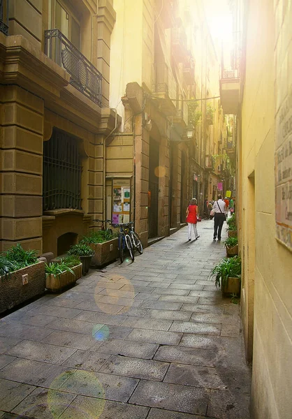 People walking down a quiet pedestrian street in Barcelona Spain