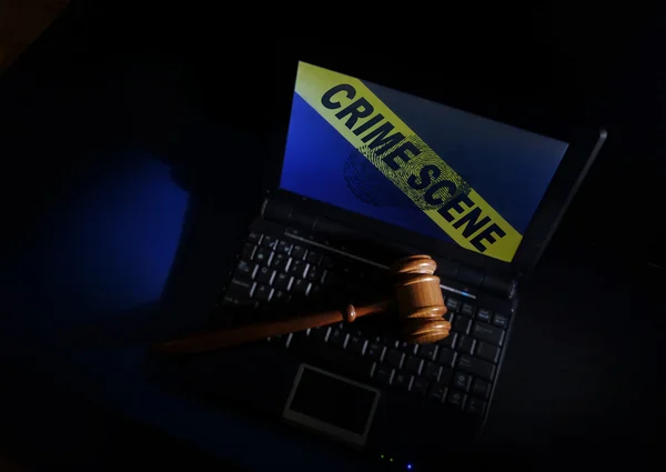 Gavel on laptop crime scene — Stock Photo, Image