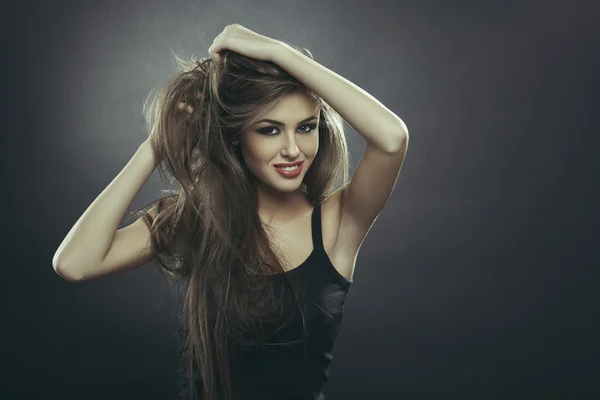 Smiling young woman with long hair — Stock Photo, Image