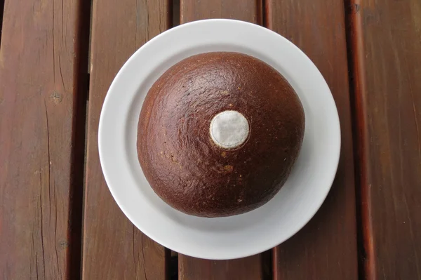 Round loaf of brown bread food in a dish