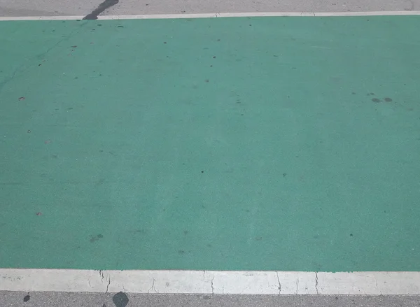 Green bike lane asphalt texture close up